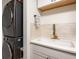 Convenient laundry area featuring a stacked washer and dryer and sink with a gold faucet at 3211 W Swann Ave # 602, Tampa, FL 33609