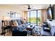 Comfortable living room with modern furniture, large windows, and a balcony offering a scenic view at 3211 W Swann Ave # 602, Tampa, FL 33609