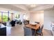 Open-concept living space with dining area, comfortable seating, and balcony access with scenic views at 3211 W Swann Ave # 602, Tampa, FL 33609