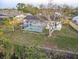 Aerial view of the property showcasing the home with screened in pool and mature trees at 3214 40Th W St, Bradenton, FL 34205