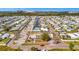 Aerial view of a well-maintained neighborhood with canals, mobile homes and community recreation center with pool at 328 S Port Royal Ln, Apollo Beach, FL 33572
