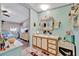 Open bathroom featuring spacious vanity with storage space and an easy-access connection to the main bedroom at 328 S Port Royal Ln, Apollo Beach, FL 33572