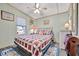 Cozy bedroom with light green walls, and a ceiling fan, featuring a patterned quilt at 328 S Port Royal Ln, Apollo Beach, FL 33572