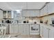 Bright kitchen features white cabinets, modern appliances, and ample counter space at 328 S Port Royal Ln, Apollo Beach, FL 33572