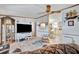 Comfortable living room featuring a ceiling fan, white chair, and view into the kitchen at 328 S Port Royal Ln, Apollo Beach, FL 33572