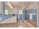 Bathroom featuring a bathtub/shower combo, a mirror, and decorative tile at 3330 San Bernadino St, Clearwater, FL 33759