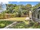 Lush green backyard with a well-maintained lawn and wooden fence, with access to a screened-in porch at 3609 S Omar Ave, Tampa, FL 33629