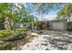 Charming single-story home with a well-manicured front yard, brick paver driveway, and mature trees at 3609 S Omar Ave, Tampa, FL 33629
