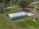Aerial view of the property showing the home, lush lawn, gazebo, and surrounding greenery at 39745 River Rd, Dade City, FL 33525