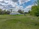 Wide angle view of property with long yard and plenty of space between neighboring houses at 39745 River Rd, Dade City, FL 33525