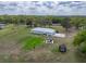 Aerial view showcasing the home, set on expansive acreage with a trampoline and gazebo at 39745 River Rd, Dade City, FL 33525