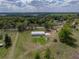 Picturesque home with lush acreage, surrounded by trees, greenery, and a trampoline at 39745 River Rd, Dade City, FL 33525