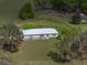Charming country home with well-maintained landscaping and surrounded by lush greenery and mature trees at 39745 River Rd, Dade City, FL 33525