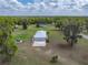 Aerial view of home, showing garage, gazebo, trampoline, and spacious lot with mature trees at 39745 River Rd, Dade City, FL 33525