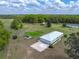 Aerial view of the property, revealing a spacious layout, featuring a gazebo, trampoline, and trees at 39745 River Rd, Dade City, FL 33525