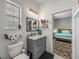 Tastefully updated bathroom with a grey vanity, modern lighting, and easy access to the Primary bedroom at 39745 River Rd, Dade City, FL 33525