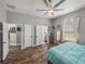 Spacious bedroom with an ensuite bathroom, ample closet space, and wood-look floors for comfort at 39745 River Rd, Dade City, FL 33525