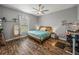 Cozy bedroom with ceiling fan, natural light, and wood-look floors creating a peaceful retreat at 39745 River Rd, Dade City, FL 33525
