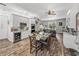 Open dining area with seating, modern cabinets, stainless appliances, and seamless flow into the living room at 39745 River Rd, Dade City, FL 33525