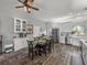 Open-concept dining space features a table set for six, and bright, neutral colors throughout at 39745 River Rd, Dade City, FL 33525