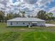 The exterior of this home features a metal roof, and a cozy front porch at 39745 River Rd, Dade City, FL 33525