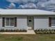 Charming single-story home featuring a metal roof, decorative shutters, and an inviting front entrance at 39745 River Rd, Dade City, FL 33525