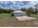 An aerial view of the side of the home showing the three-car garage, and stone landscaping at 39745 River Rd, Dade City, FL 33525