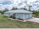Aerial view of the home highlighting the three car garage, covered patio and spacious yard at 39745 River Rd, Dade City, FL 33525