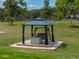 Close-up of gazebo on a wood platform featuring a swing and privacy curtains at 39745 River Rd, Dade City, FL 33525