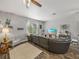 Comfortable living room with a large leather couch, wood-look floors, and lots of natural light at 39745 River Rd, Dade City, FL 33525