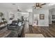 Open-concept living space with wood-look floors, connecting the living room, kitchen, and bathroom at 39745 River Rd, Dade City, FL 33525