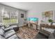 Cozy living room with wood-look floors, decorative accents, and lots of natural light at 39745 River Rd, Dade City, FL 33525