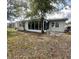 Charming backyard view highlighting the enclosed porch area and surrounding greenery at 4033 Newcastle Dr, New Port Richey, FL 34652
