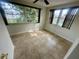Bright bedroom with ample natural light, tiled flooring, and a ceiling fan at 4033 Newcastle Dr, New Port Richey, FL 34652