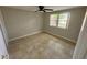 Neutral bedroom with tiled flooring, ceiling fan, and a window allowing natural light at 4033 Newcastle Dr, New Port Richey, FL 34652