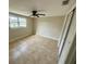 Bedroom featuring tiled flooring, ceiling fan, a large window, and a closet at 4033 Newcastle Dr, New Port Richey, FL 34652