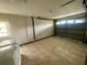 Spacious garage featuring tile flooring and a large door for easy vehicle access at 4033 Newcastle Dr, New Port Richey, FL 34652