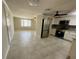 Well-lit kitchen with stainless steel appliances, white cabinetry, and tiled flooring at 4033 Newcastle Dr, New Port Richey, FL 34652