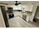 Modern kitchen featuring white cabinets, stainless steel appliances, and granite countertops at 4033 Newcastle Dr, New Port Richey, FL 34652