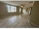 Interior features tiled flooring and neutral paint, along with a ceiling fan and large window at 4033 Newcastle Dr, New Port Richey, FL 34652