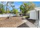 View of the spacious backyard with a storage shed and partial white fence at 4421 W Iowa Ave, Tampa, FL 33616