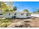 Backyard view features a screened-in porch and a well-maintained lawn at 4421 W Iowa Ave, Tampa, FL 33616