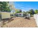 Spacious backyard featuring a white fence, screened-in porch, storage shed and mature trees at 4421 W Iowa Ave, Tampa, FL 33616