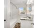Bathroom featuring a tiled shower and vanity with granite at 4421 W Iowa Ave, Tampa, FL 33616