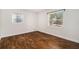 Bright bedroom with two windows and wood-look flooring at 4421 W Iowa Ave, Tampa, FL 33616