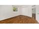 Bedroom with hardwood floors, closet, and natural light at 4421 W Iowa Ave, Tampa, FL 33616