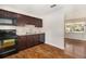 Modern kitchen featuring dark cabinets, stainless appliances, and a view into the living room at 4421 W Iowa Ave, Tampa, FL 33616