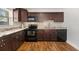 Beautiful kitchen with dark wood cabinetry, stainless steel appliances, and stylish countertops at 4421 W Iowa Ave, Tampa, FL 33616