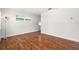 Bright living room with beautiful hardwood floors and natural light from the window at 4421 W Iowa Ave, Tampa, FL 33616