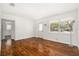 Open living room featuring gorgeous wood floors, white walls, and natural light at 4421 W Iowa Ave, Tampa, FL 33616